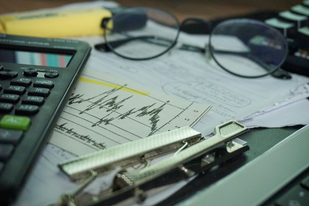 Financial analyst workstation with stock data, calculator and desk illustrating enterprise AI dataset pricing decisions